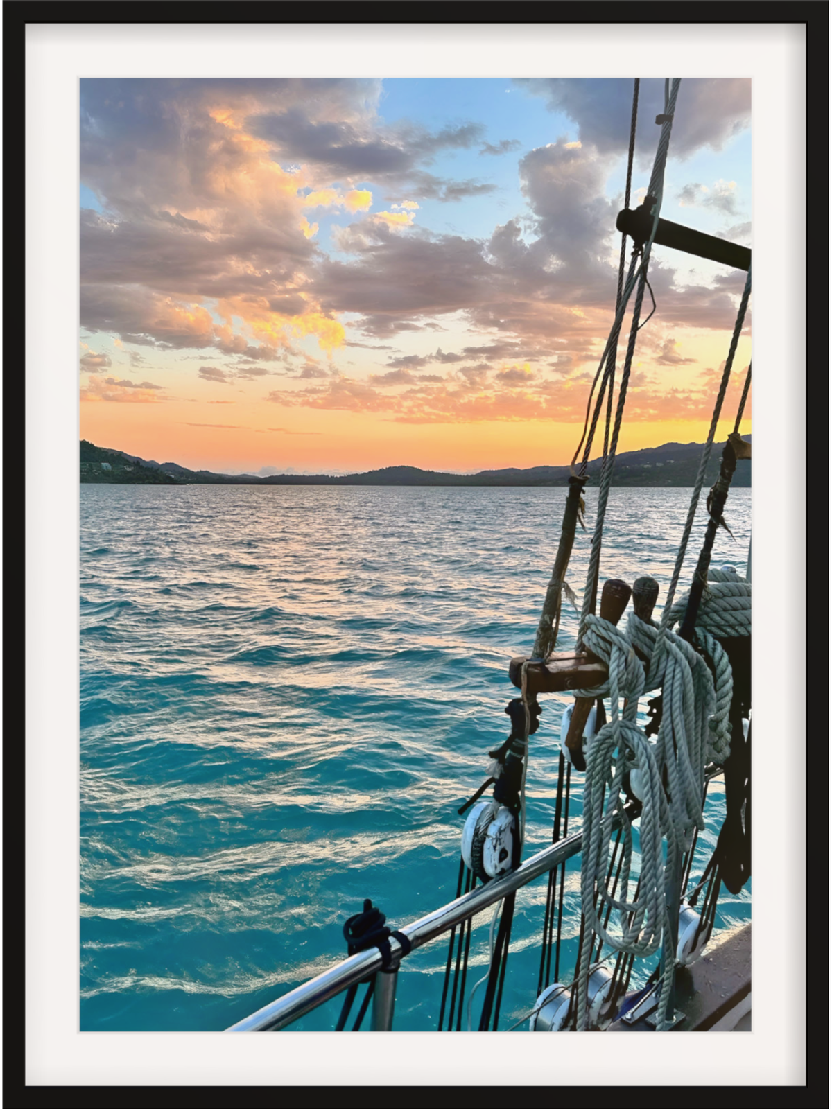 Sailing ship on the ocean at sunset