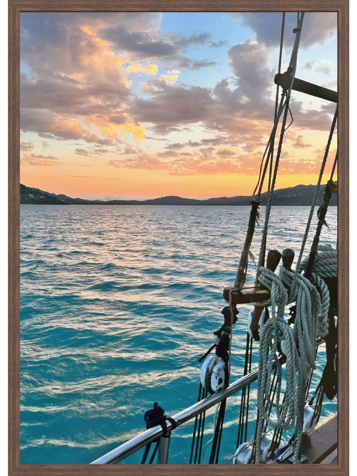Sailing ship on the ocean with a sunset sky