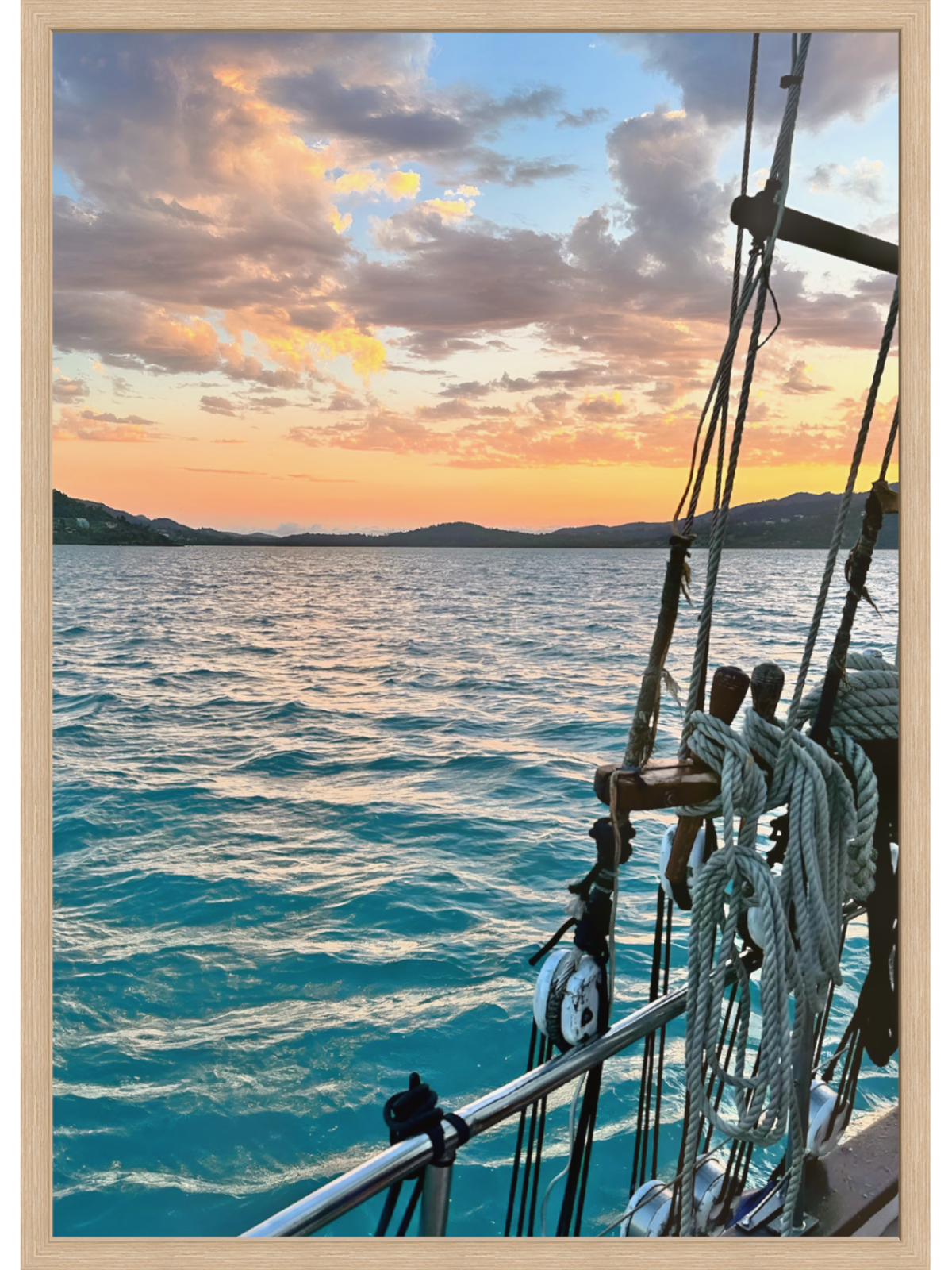 Sailboat on the water with a sunset sky