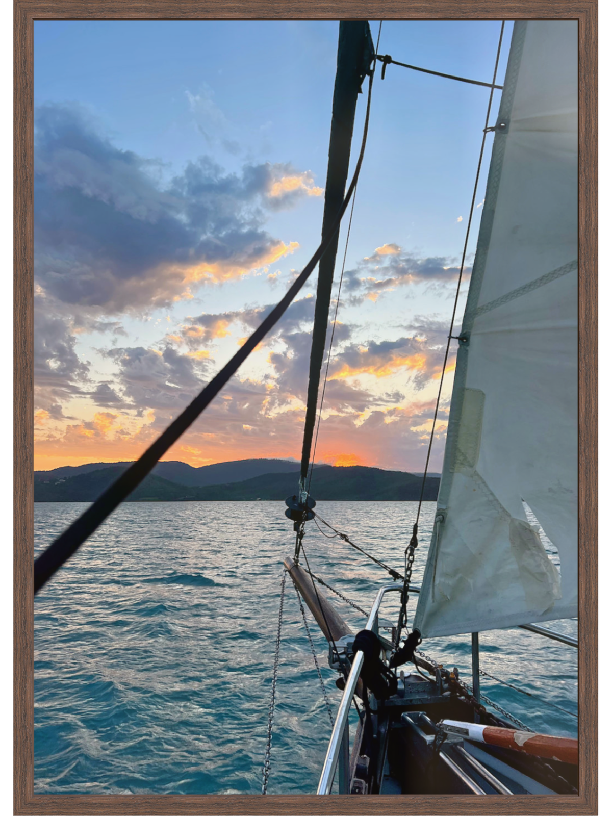 Sailboat on the water with a sunset sky