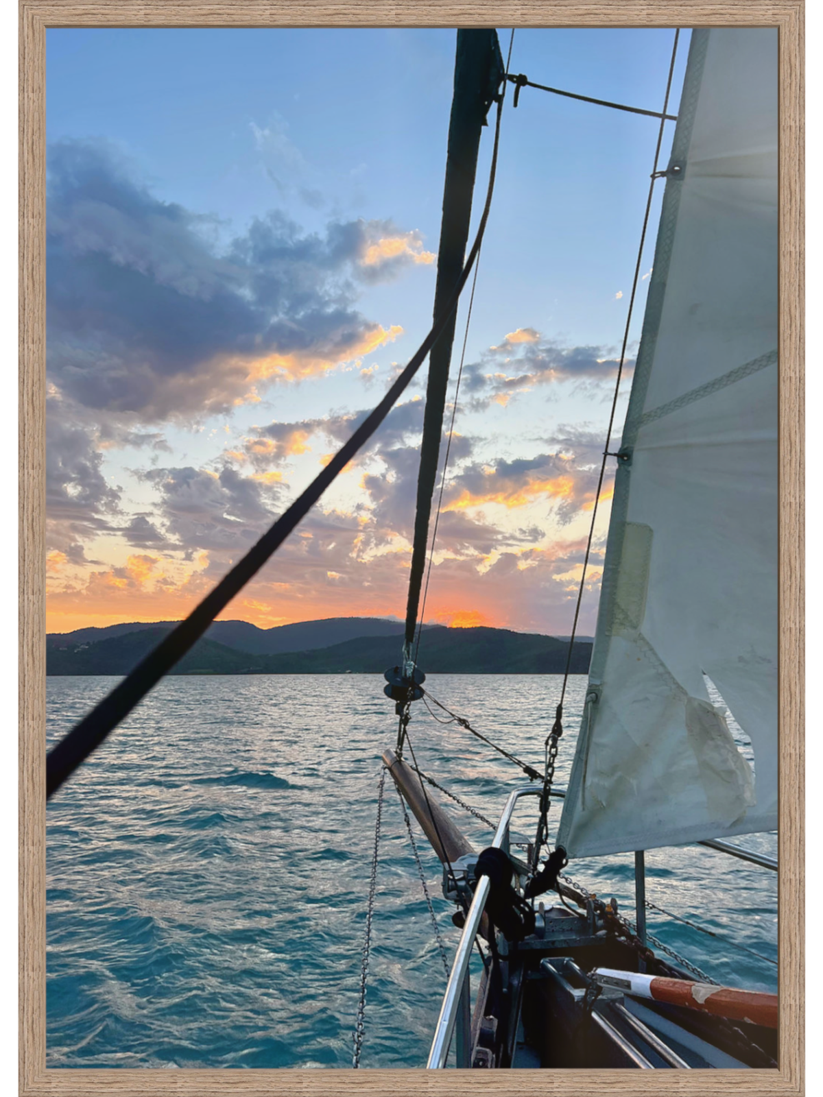 Sailboat on the water with a sunset sky