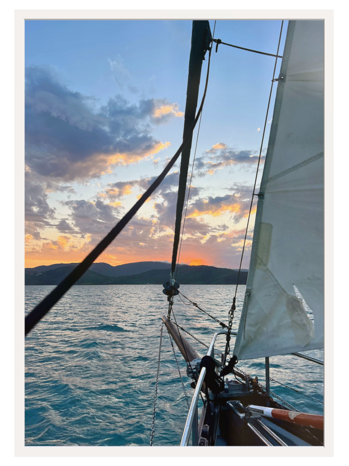 Sailboat on the water with a colorful sunset sky