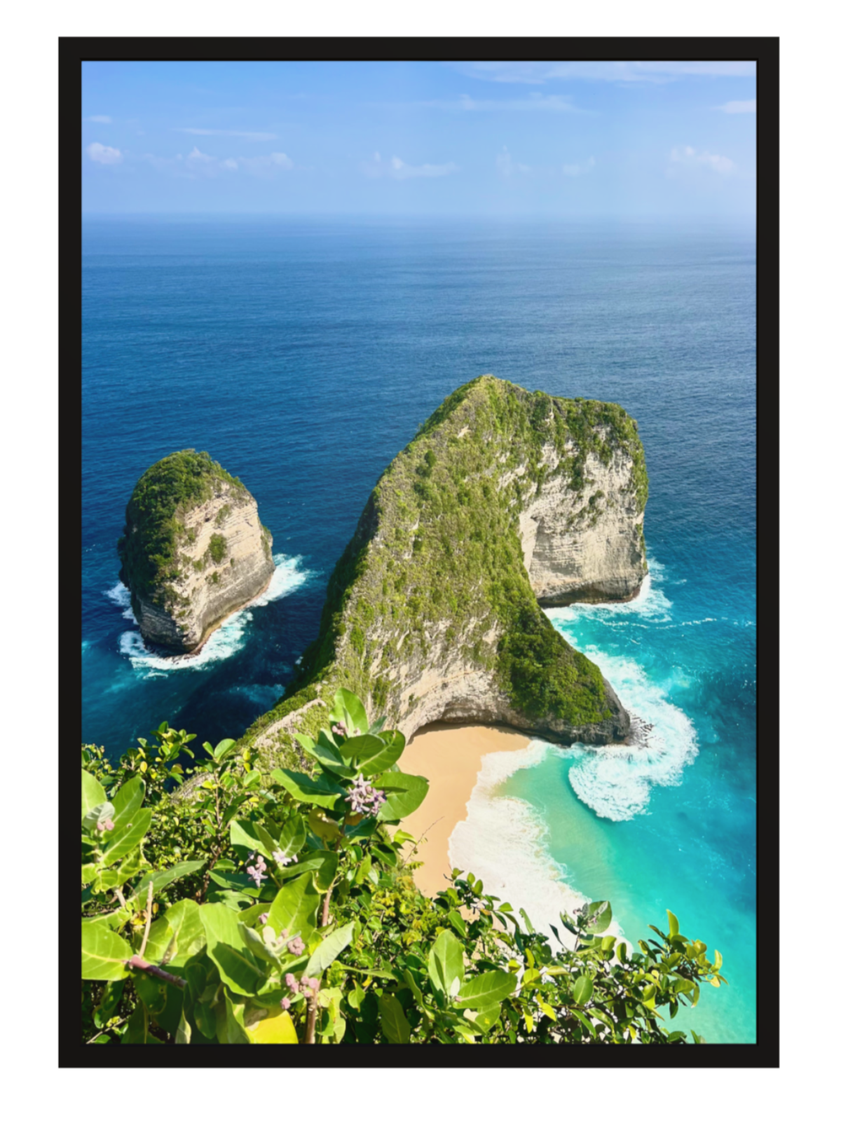 black frame Aerial view of a tropical island with rocky outcrops and a sandy beach.
