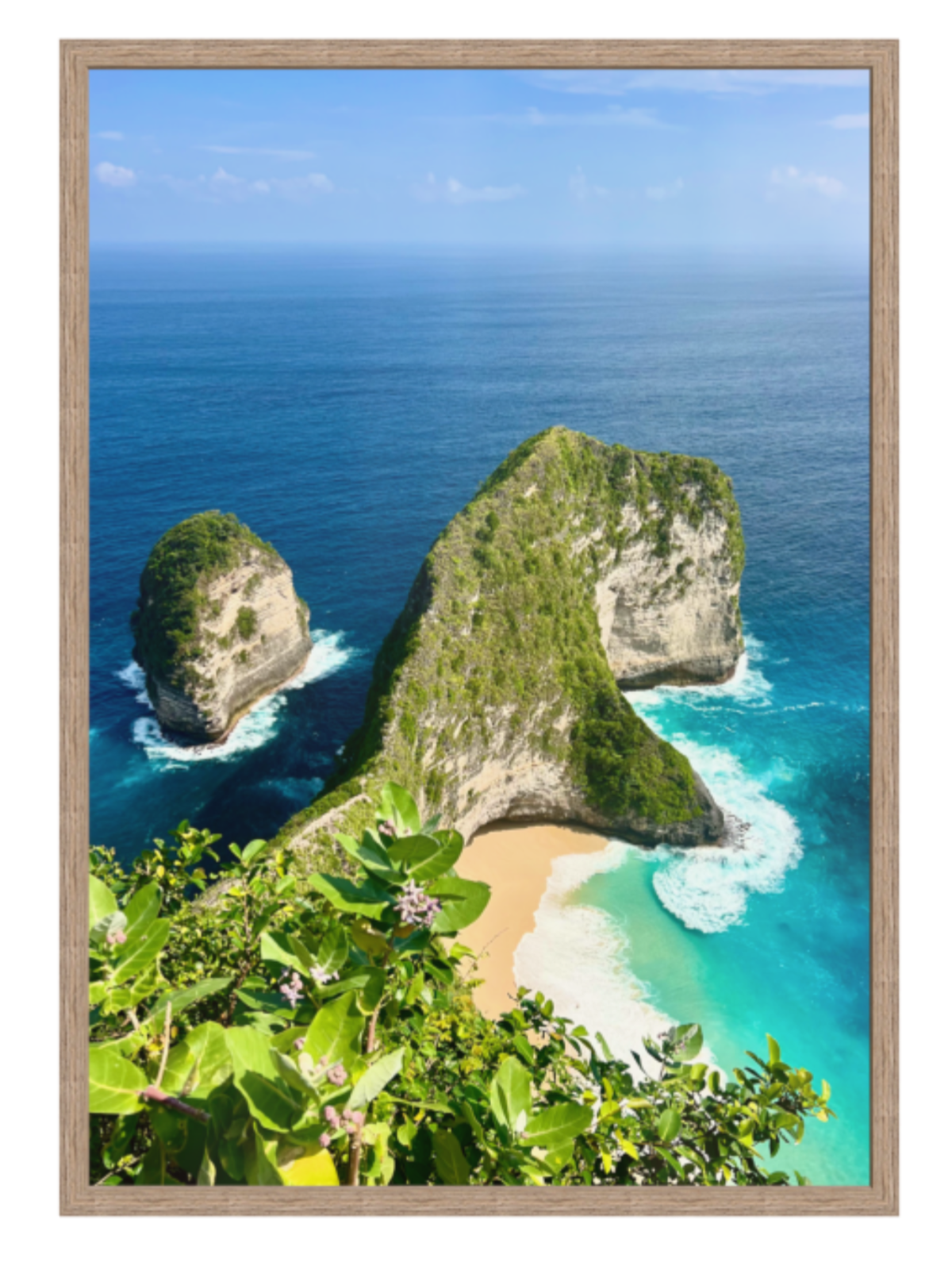 hazel Framed photograph of a tropical island with rocky outcrops and clear blue water.