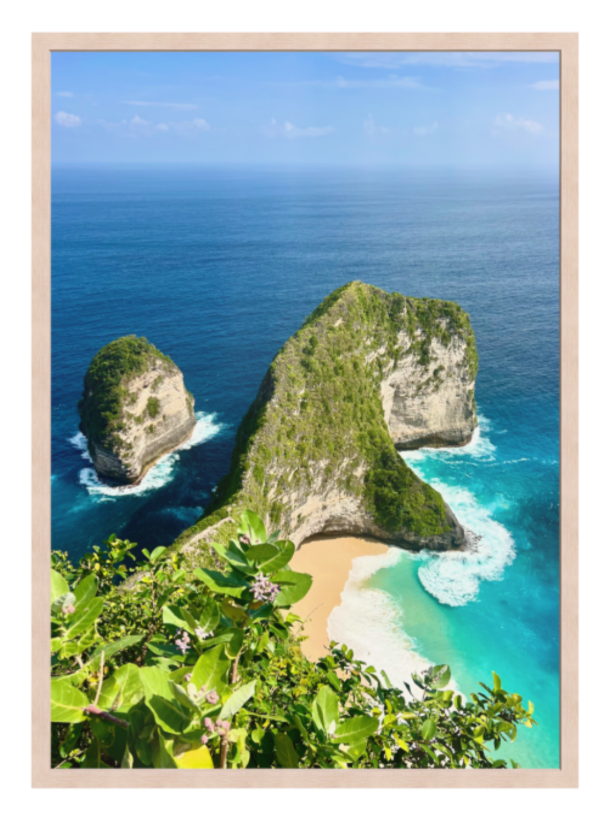 light oak Framed artwork of a tropical island with rocky outcrops and turquoise water.