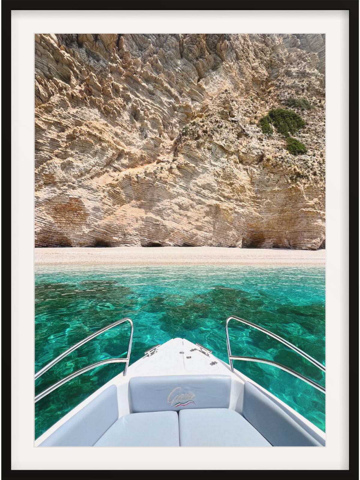 Boat on clear turquoise water with rocky cliffs in the background