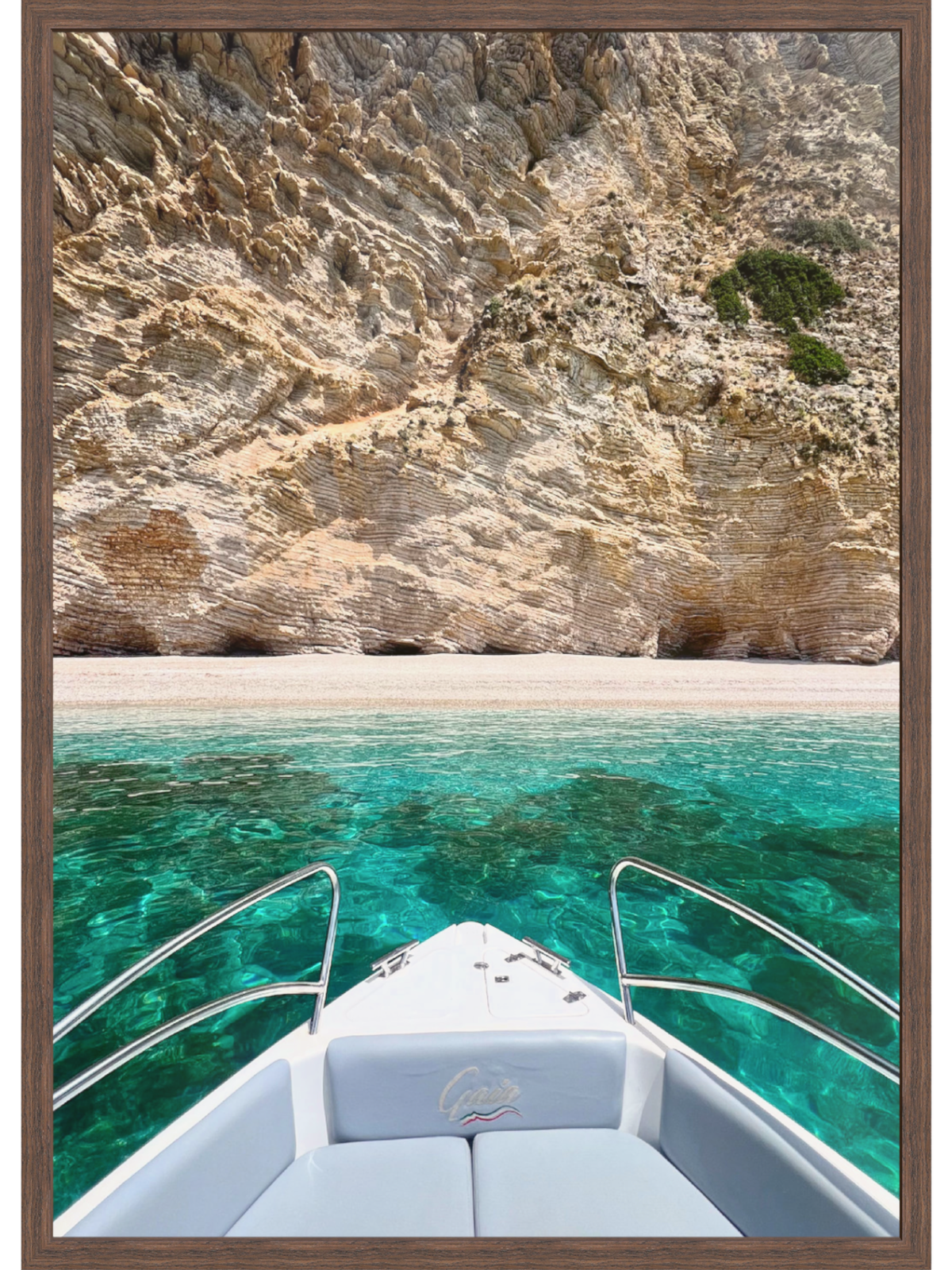 Boat on turquoise water with rocky cliffs in the background