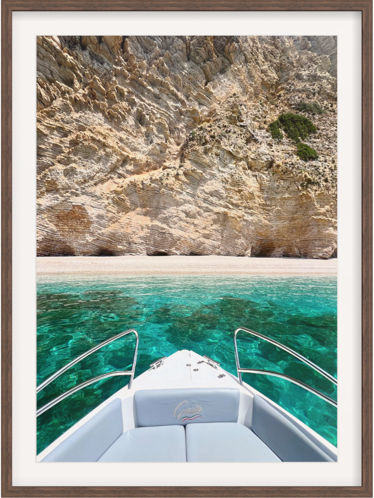 Boat on clear blue water with rocky cliffs in the background