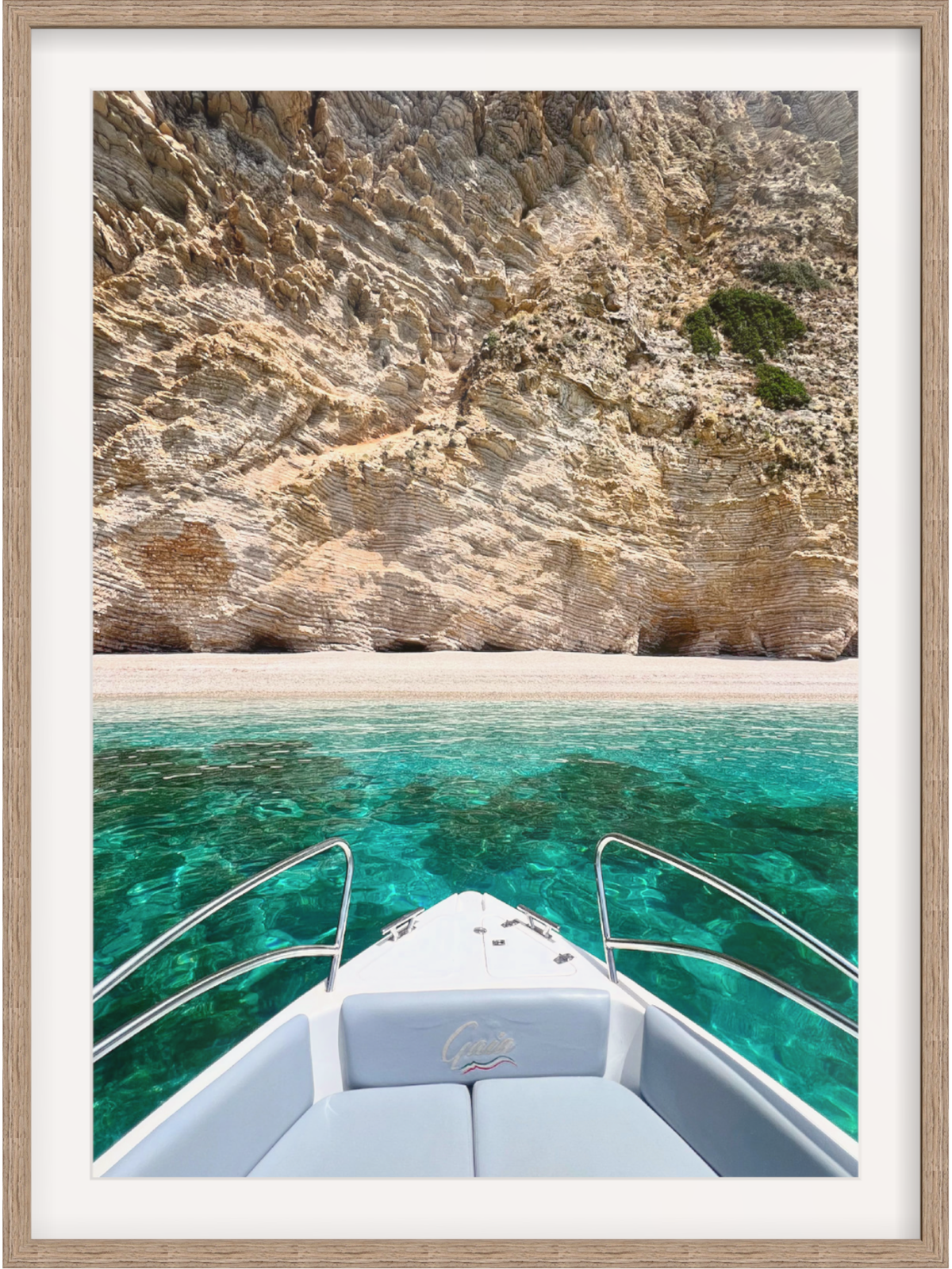 Boat on clear blue water with rocky cliffs in the background