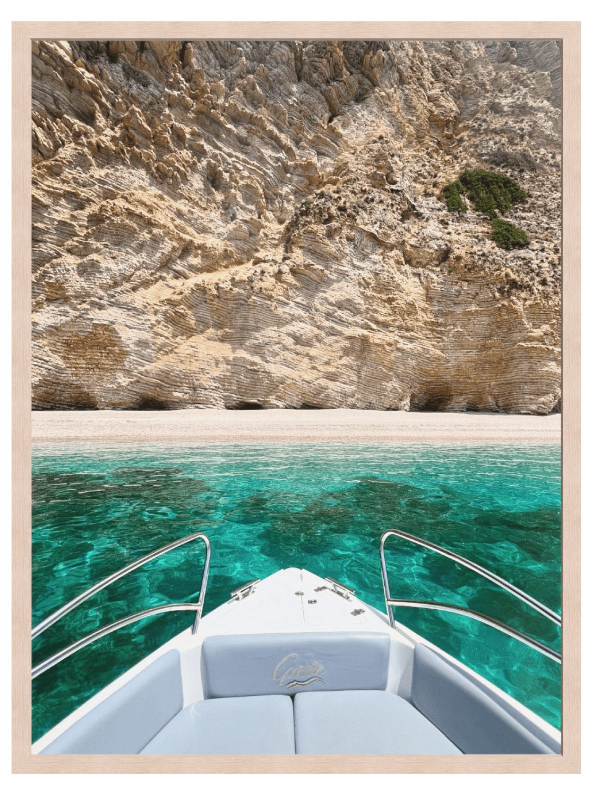 Boat on turquoise water with rocky cliffs in the background
