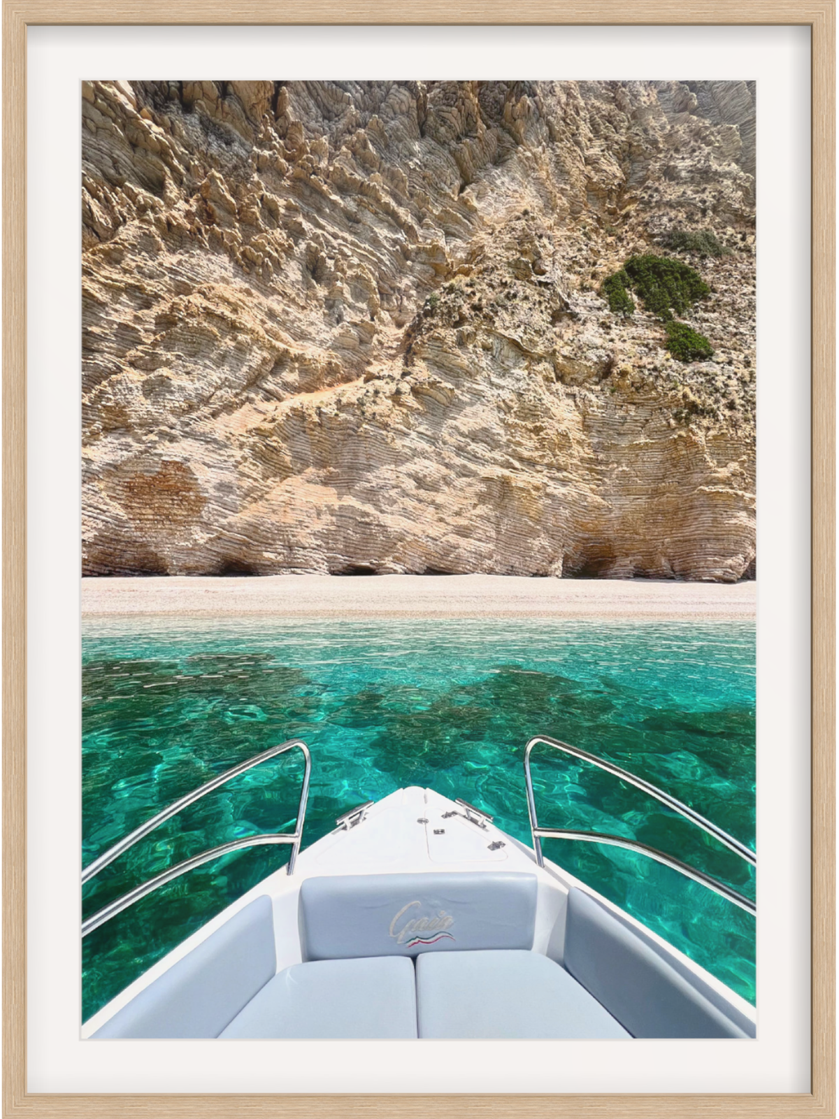 Boat on clear blue water with rocky cliffs in the background