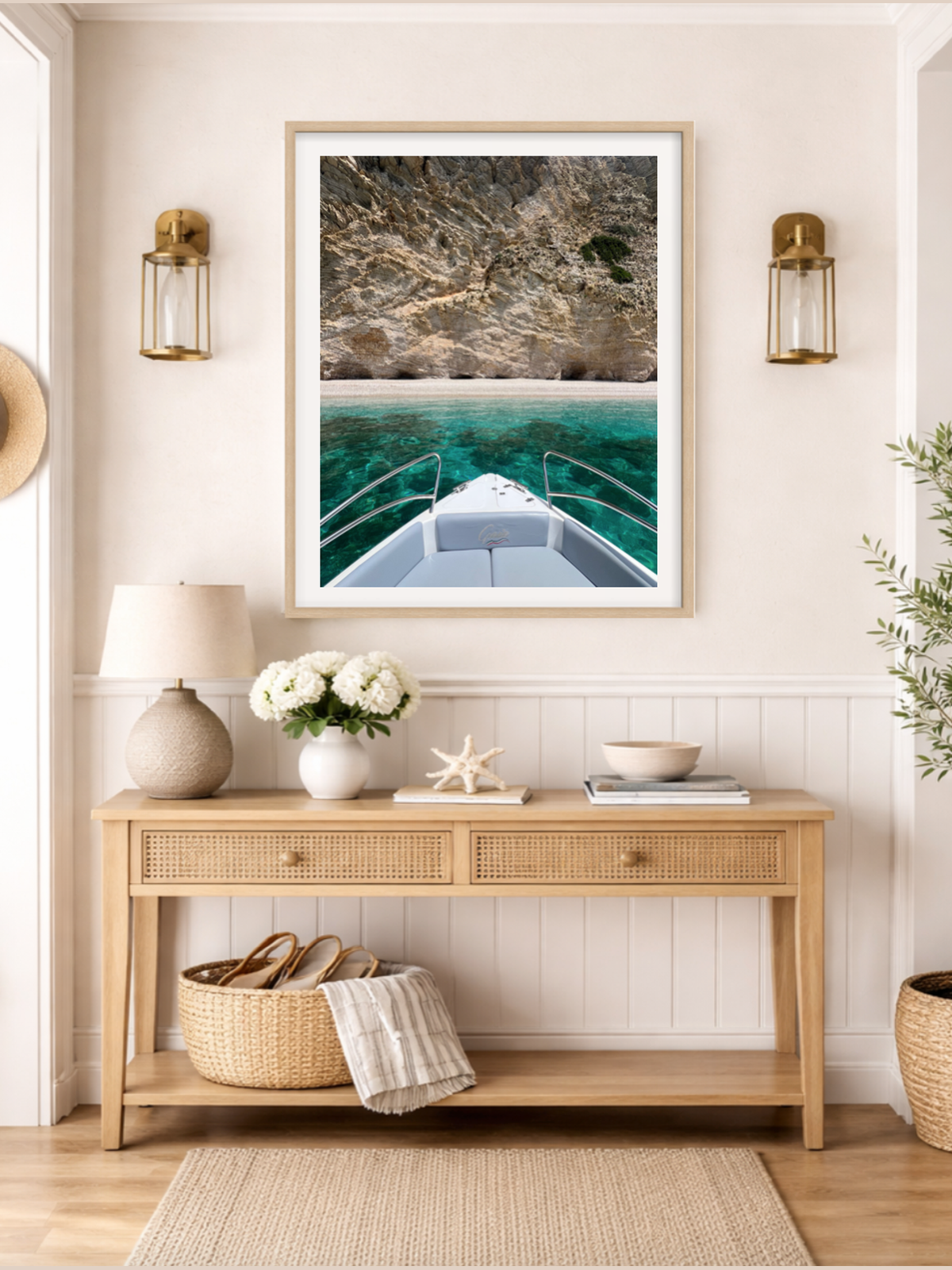 Nautical-themed interior with a framed picture of a boat, lamp, and decorative items on a wooden console table.