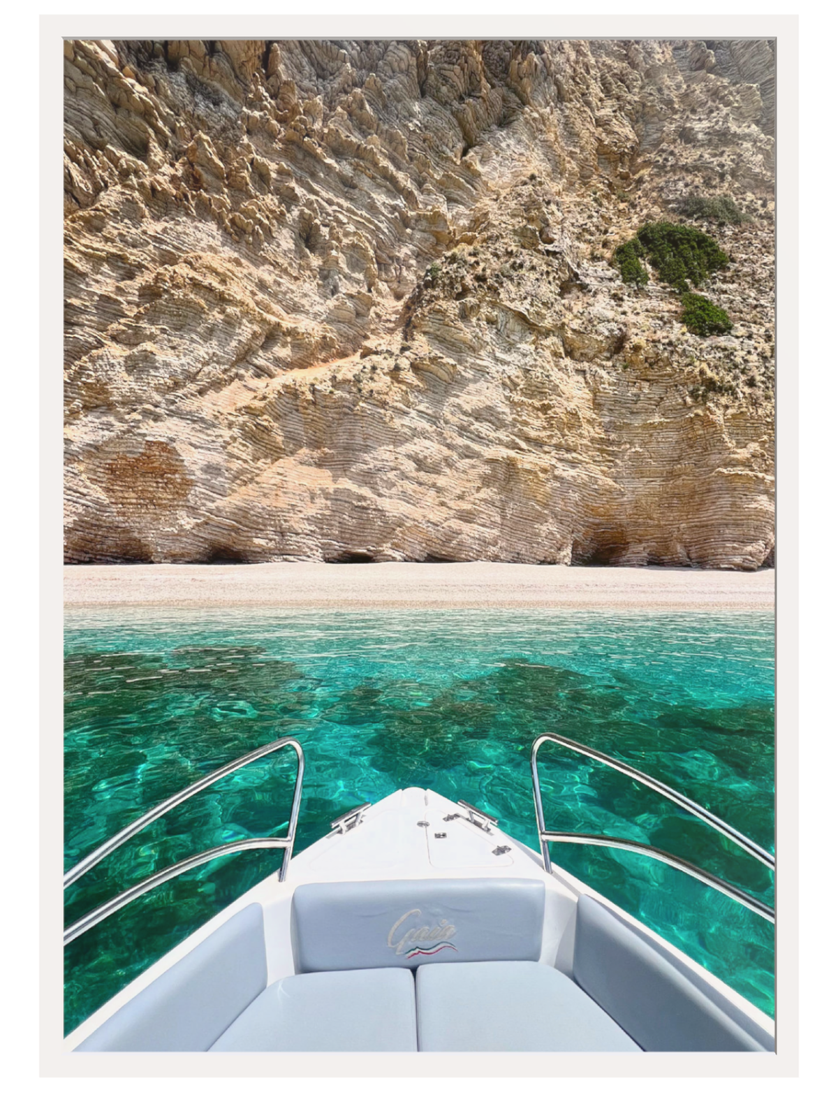 Boat on clear blue water with rocky cliffs in the background