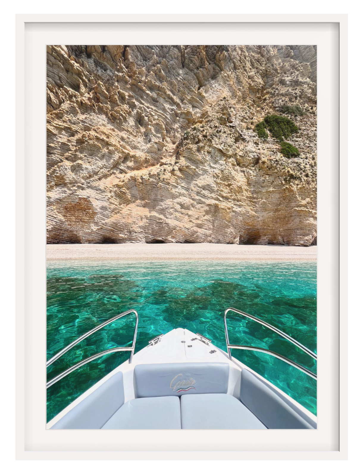 Boat on clear blue water with rocky cliff in the background