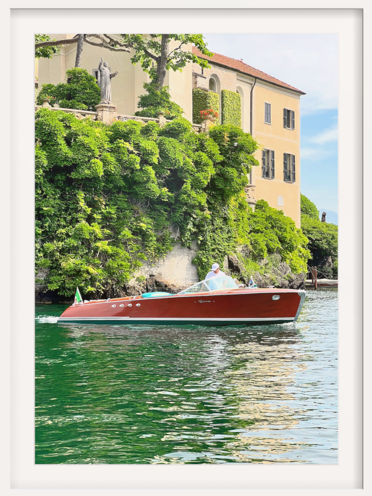 Red boat on a body of water with a scenic background