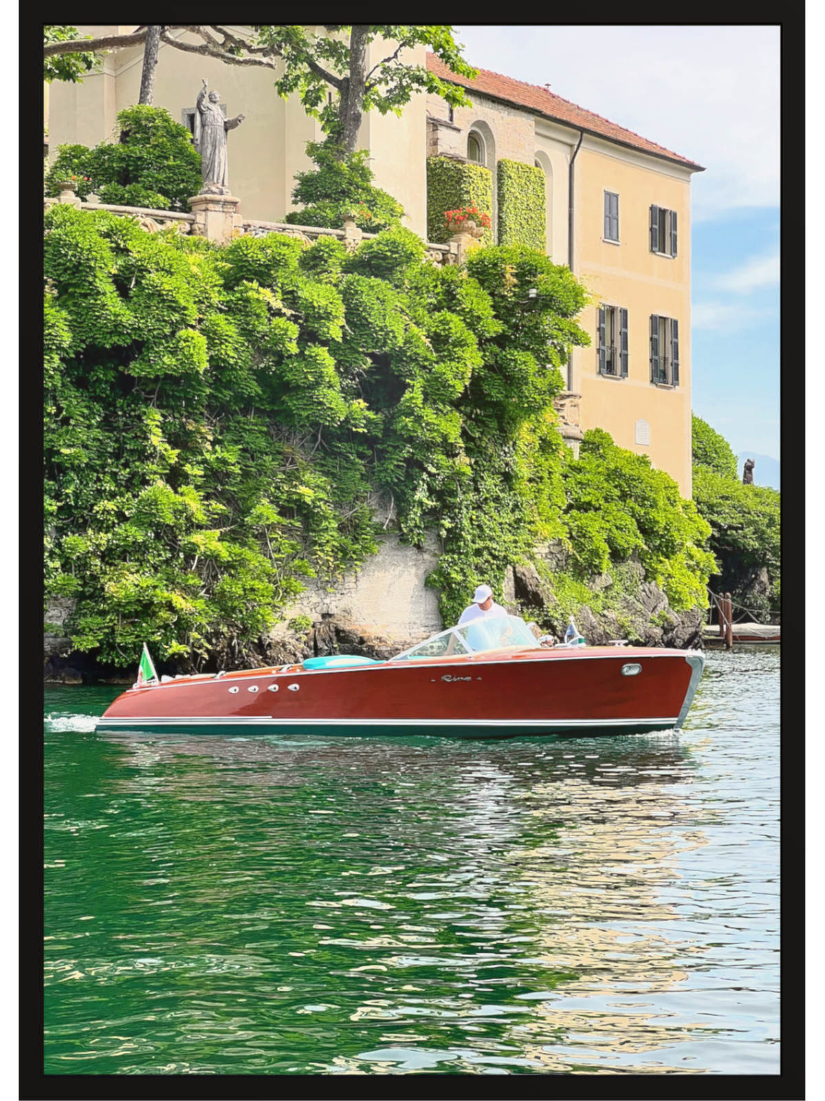 Red boat on a body of water with a scenic background