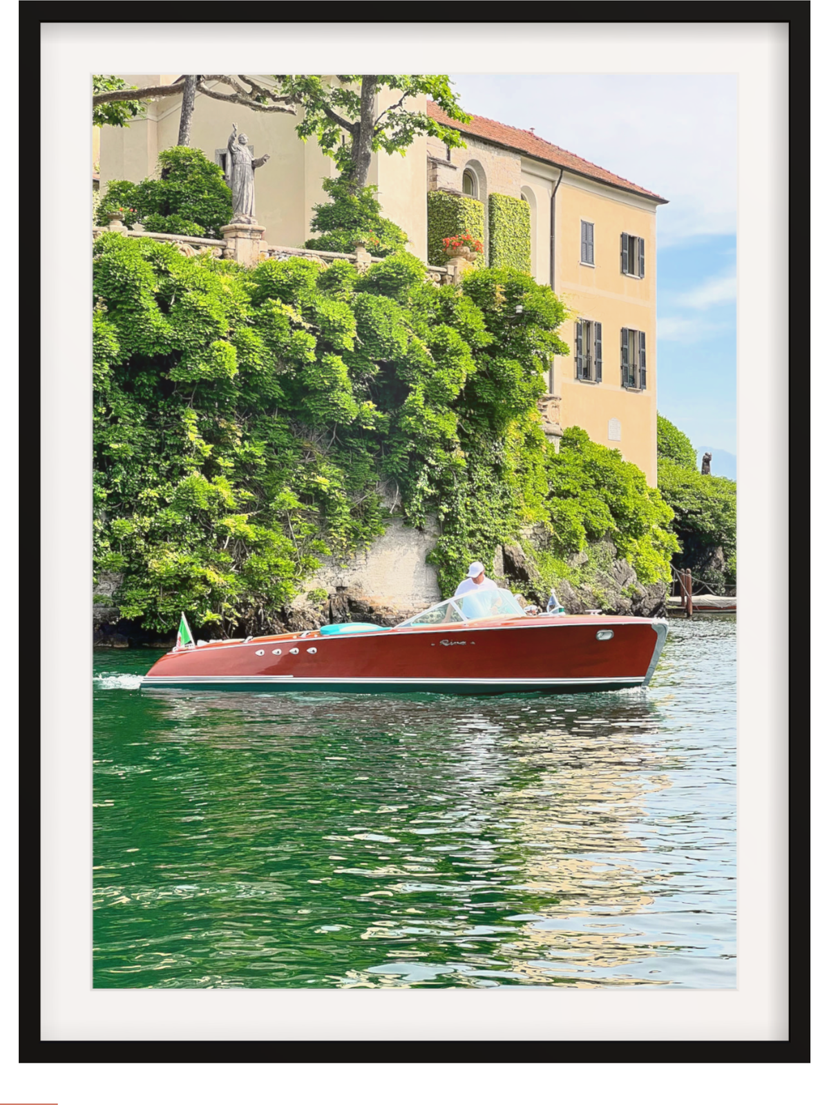 Red boat on a body of water with a scenic background