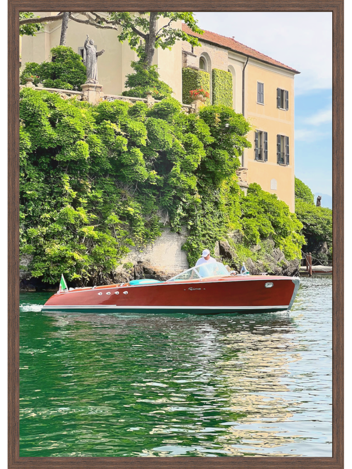 Red boat on a body of water with a scenic background