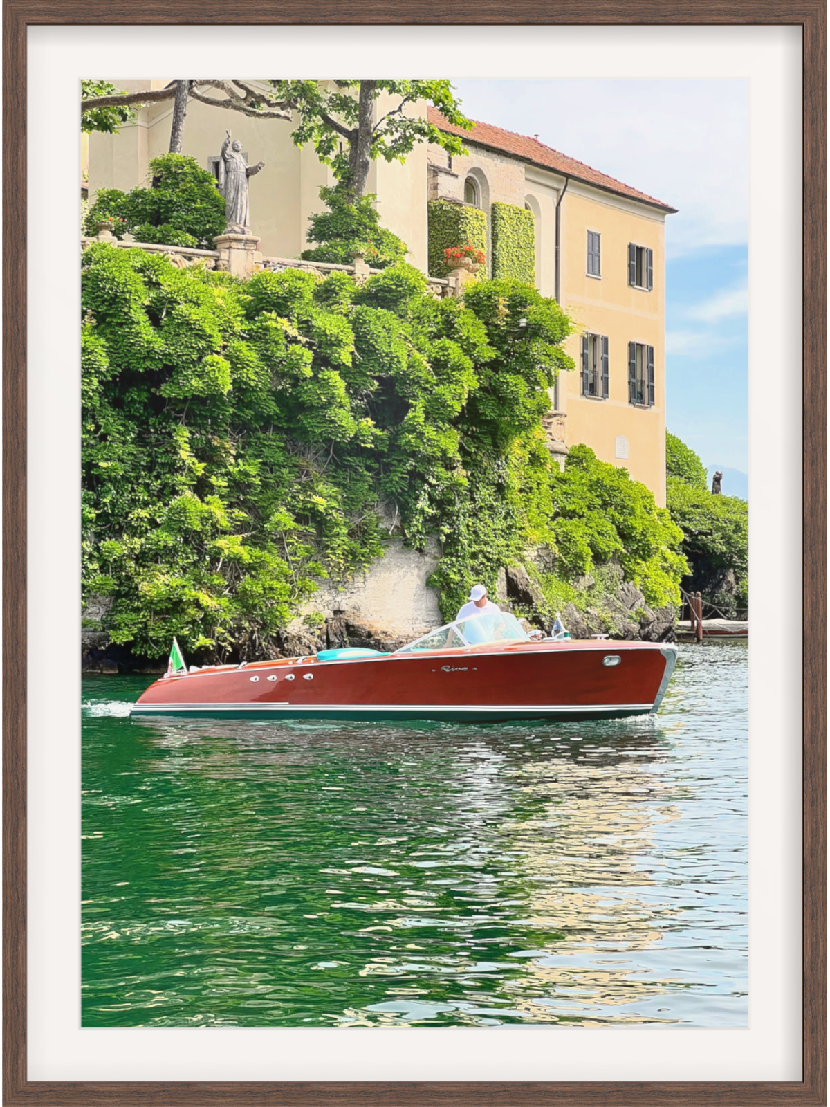 Red boat on a body of water with a scenic background