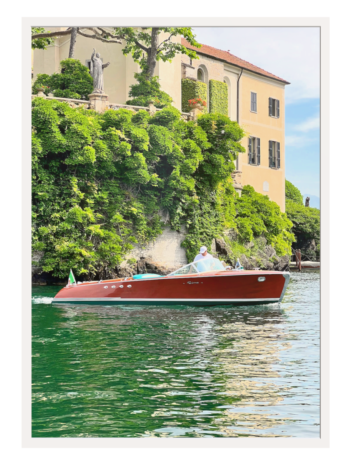 Red boat on a body of water with a scenic background