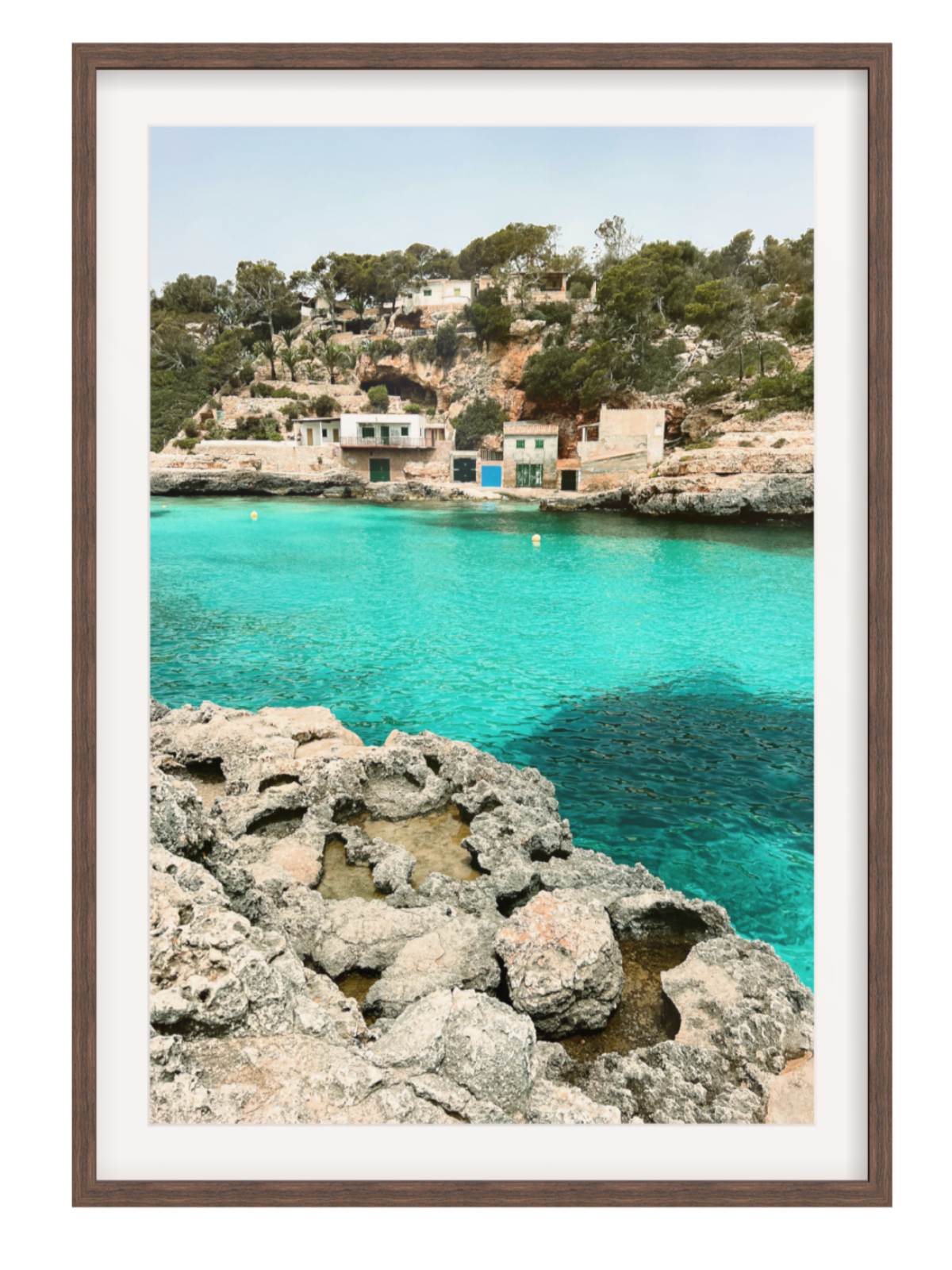 Framed photograph of a coastal scene with turquoise water and rocky foreground chocolate frame with border