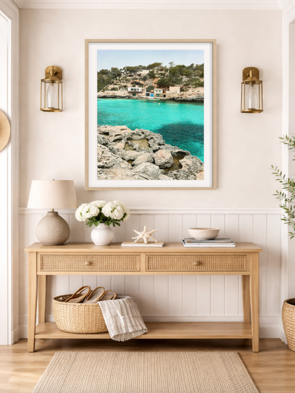 Nautical-themed room with a framed picture of a coastal scene, wooden console table, and decorative items.