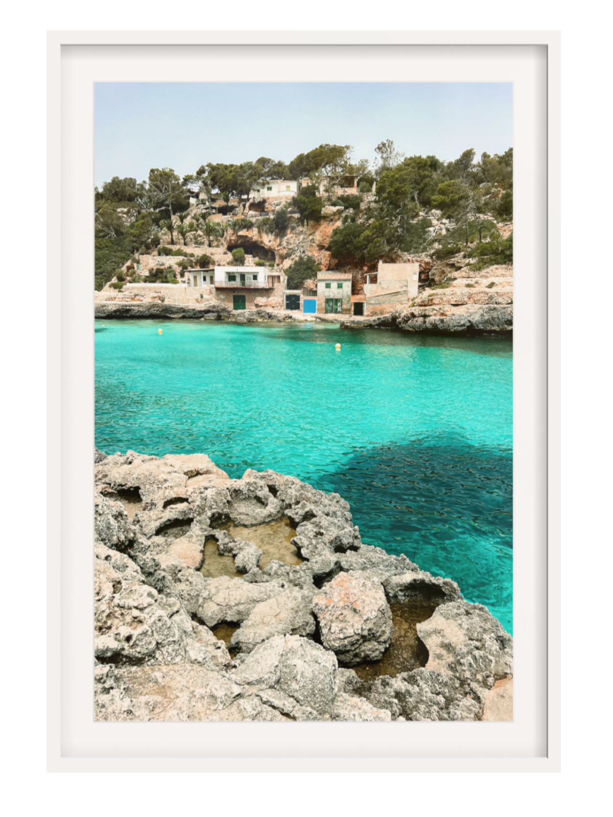 Framed photograph of a coastal scene with turquoise water and rocky foreground