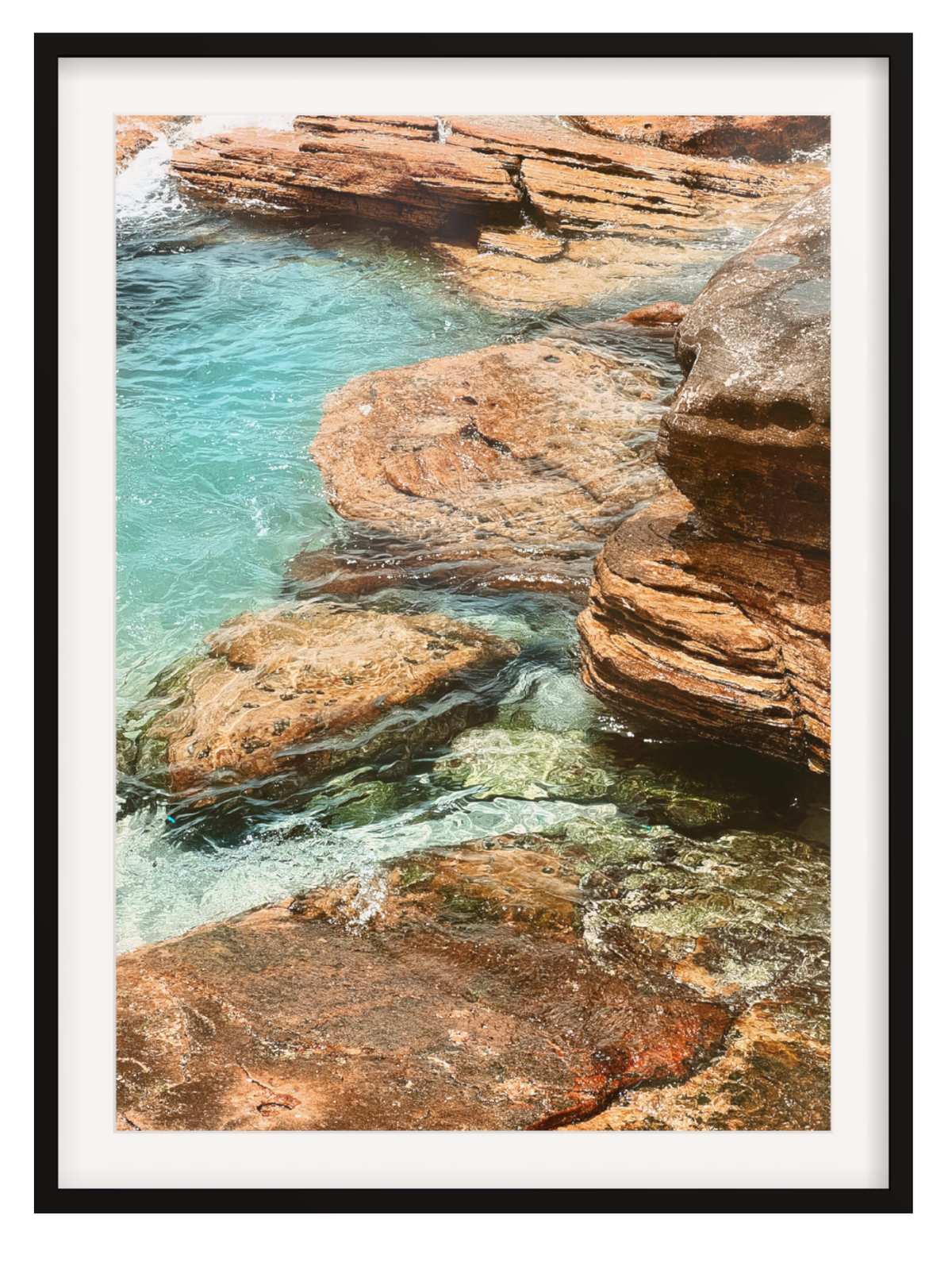 Framed photograph of rocky coastline with clear blue water